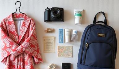 A visually appealing flat lay of travel essentials including a yukata, camera, and map for a Japan packing checklist
